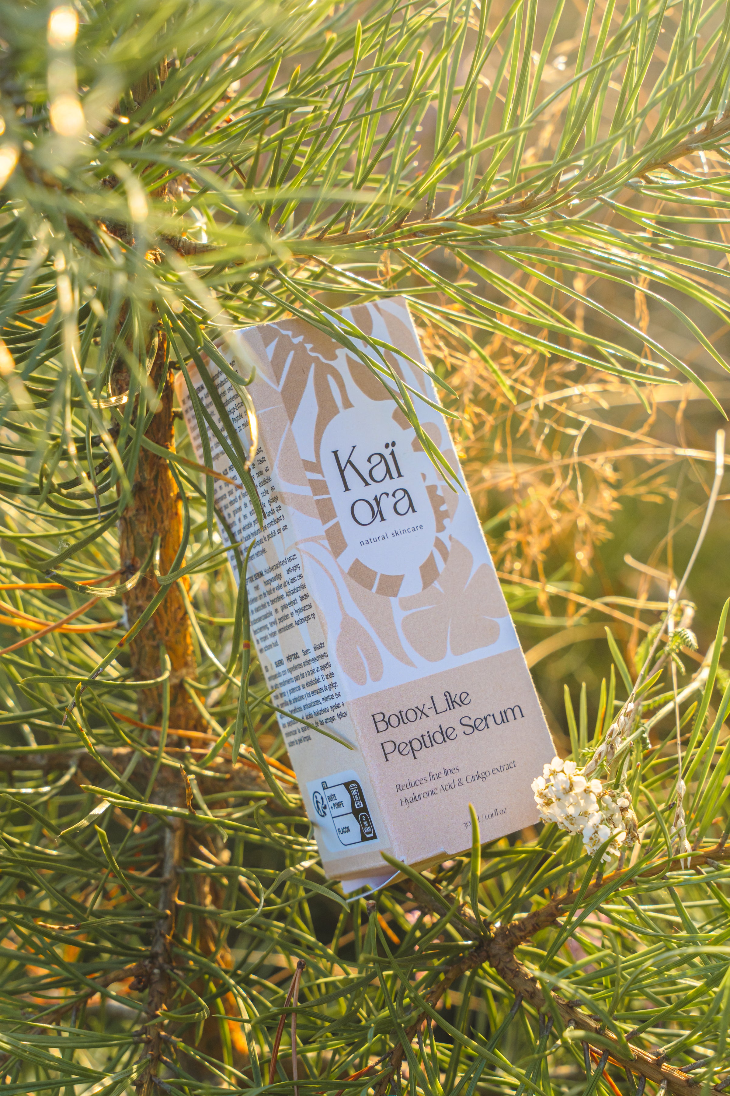 Kai Ora product packaging hanging from a tree