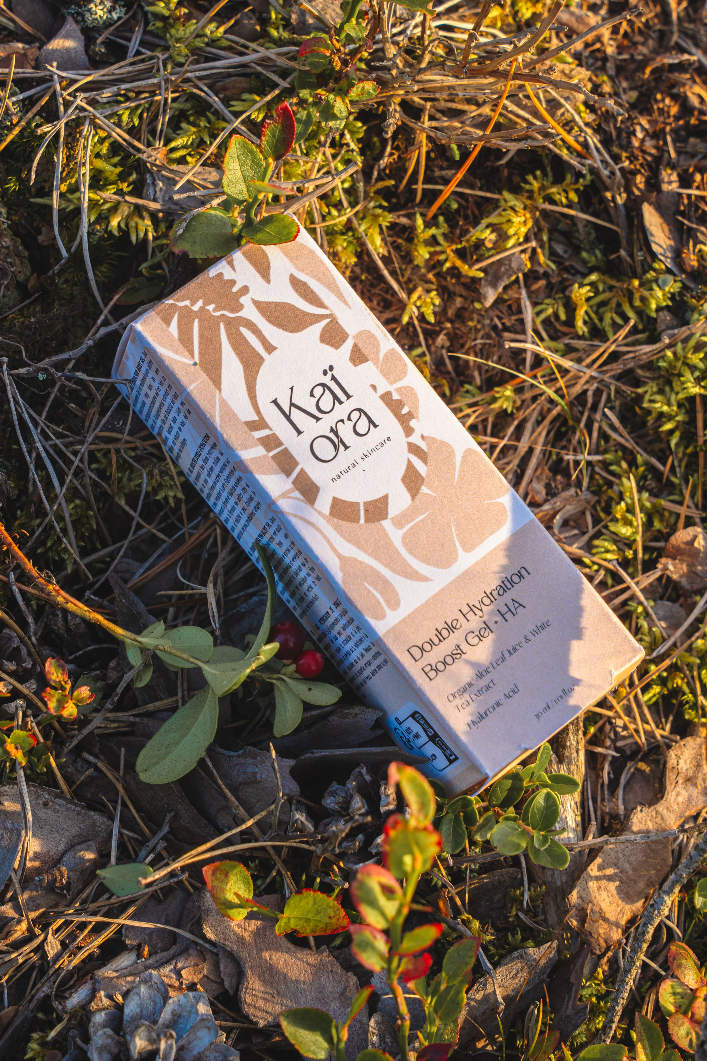 Kai Ora product packaging on a natural background with plants and leaves.